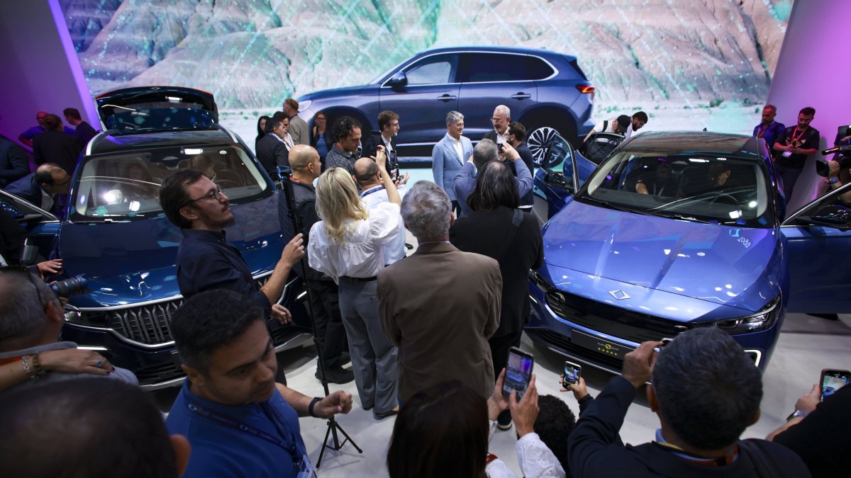 Togg&#039;s T10X electric SUV (L) and the newly unveiled T10F sedan are seen during a press conference at the IAA Mobility auto show, Munich, Germany, Sept. 8, 2025. (EPA Photo)