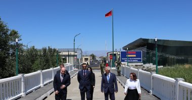 Türkiye&#039;s representative, Ambassador Serdar Kılıç (2nd R), and Armenia&#039;s representative, Ruben Rubinyan (2nd L), walk on the border between the two countries, July 30, 2024. (AA Photo)