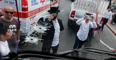 People inspect a bus with bullet holes at the scene where a suspected shooting attack took place at the outskirts of Jerusalem, September 8, 2025 REUTERS/Ammar Awad