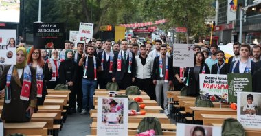 The Justice and Development Party (AK Party) Youth Branch Chair Yusuf Ibiş and members of the youth branches place photos of children killed in Gaza on empty desks during a commemoration, Kızılay Square, Ankara, Türkiye, Sept. 8, 2025. (DHA Photo)