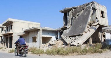 A man rides a motorbike past a damaged building in Homs, Syria Nov. 7, 2024. (Reuters File Photo)