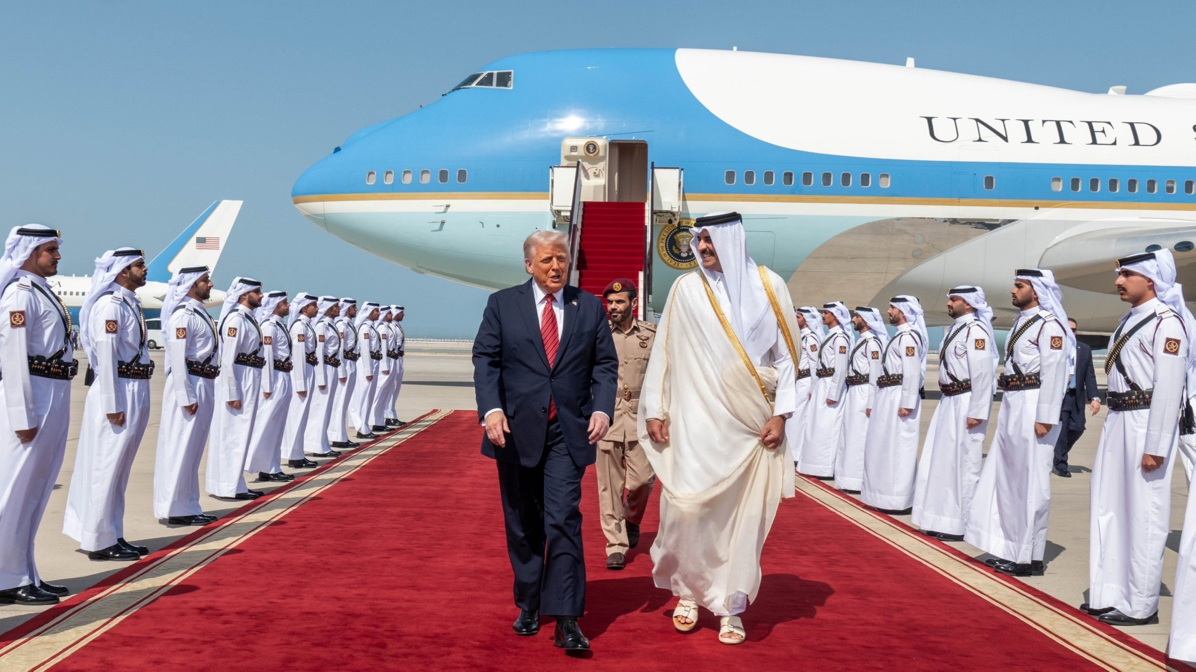 U.S. President Donald Trump (L) walks with Qatar's Emir Tamim bin Hamad Al Thani after landing at the Hamad International Airport, Doha, Qatar, May 14, 2025. (AA File Photo)