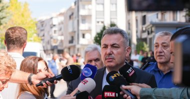 Izmir Governor Süleyman Elban is seen speaking to the press in front of the Balçova police station, Izmir province, Türkiye, Sept. 8, 2025 (AA Photo)