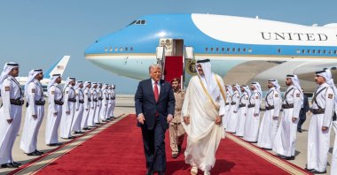 U.S. President Donald Trump (L) walks with Qatar's Emir Tamim bin Hamad Al Thani after landing at the Hamad International Airport, Doha, Qatar, May 14, 2025. (AA File Photo)