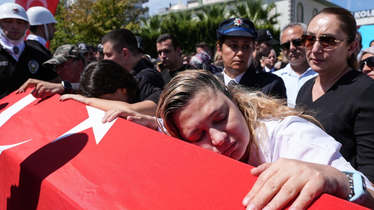 Ebru Aydemir (R) and others mourn during the funeral of police officer Muhsin Aydemir, who was killed when a 16-year-old opened fire at a police station, Balçova, Izmir, Türkiye, Sept. 9, 2025. (AA Photo)