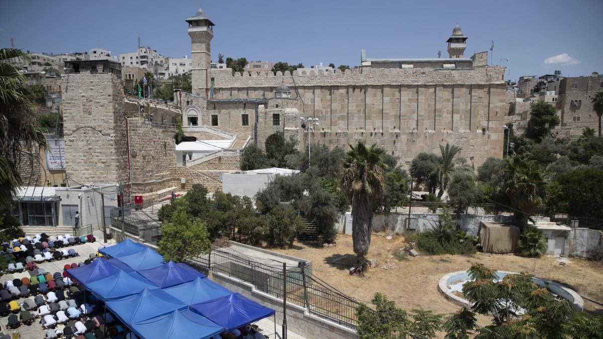 Palestinians pray during Friday prayers at a protest against Israeli construction access to alter the status of the Ibrahimi Mosque, in the city of Hebron, occupied West Bank Friday, Aug. 13, 2021. (AP File Photo)