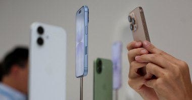 A person uses a phone to capture iPhones on display during Apple&#039;s event at the Steve Jobs Theater, Cupertino, California, U.S., Sept. 9, 2025. (Reuters Photo)