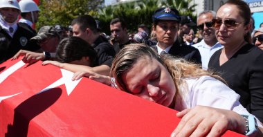 Ebru Aydemir (R) and others mourn during the funeral of police officer Muhsin Aydemir, who was killed when a 16-year-old opened fire at a police station, Balçova, Izmir, Türkiye, Sept. 9, 2025. (AA Photo)