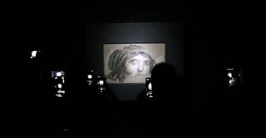 Visitors explore and take pictures of the “Gypsy Girl” mosaic at the Zeugma Mosaic Museum, Gaziantep, southeastern Türkiye, Aug. 31, 2025. (AA Photo)