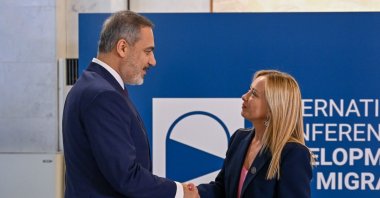 Foreign Minister Hakan Fidan shakes hands with Italian Prime Minister Giorgia Meloni as he arrives for a migration summit, Rome, Italy, July 23, 2023. (AA Photo)