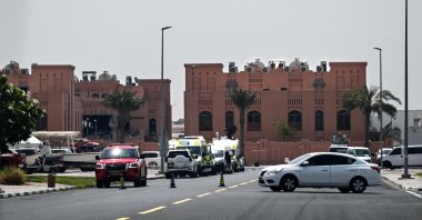 A picture taken from a distance shows the damaged building (L) in the compound housing members of the Palestinian resistance group Hamas&#039;s political bureau targeted by an Israeli strike, Doha, Qatar, Sept. 10, 2025. (AFP Photo)