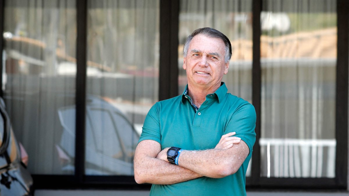 Former Brazilian President Jair Bolsonaro gestures at the garage of his residence in Brasilia, Brazil, Sept. 11, 2025. (AFP Photo)