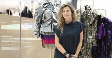In this undated photo, Belma Özdemir, president of the Fashion Designers Association, poses among designs showcased at IFCO. (Courtesy of Belma Özdemir)