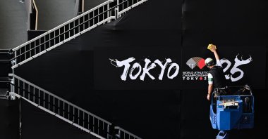 A worker wipes a canvas in the Japan National Stadium ahead of the World Athletics Championships Tokyo 25, Tokyo, Japan, Sept. 11, 2025. (EPA Photo)