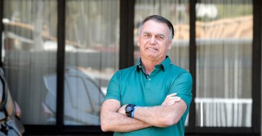 Former Brazilian President Jair Bolsonaro gestures at the garage of his residence in Brasilia, Brazil, Sept. 11, 2025. (AFP Photo)