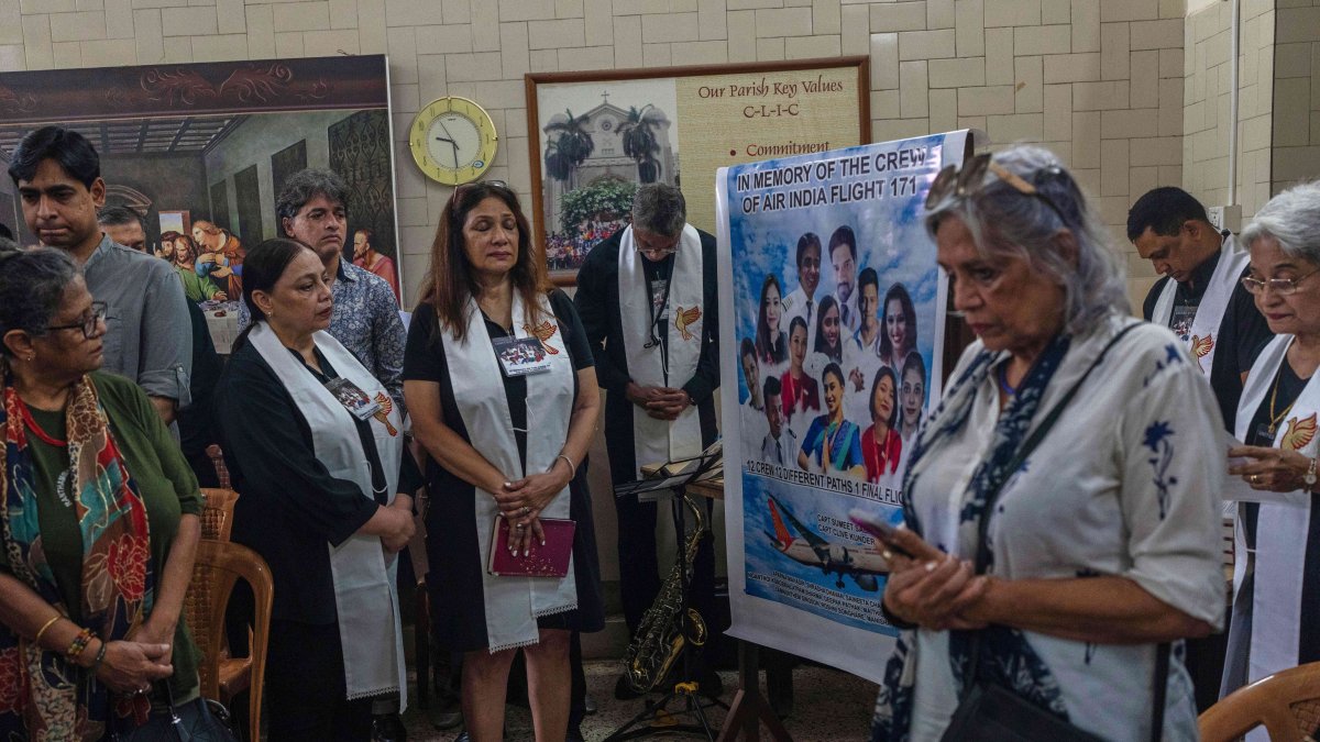 People offer prayers for crew members of the Air India flight that crashed in Ahmedabad last month during a prayer meeting at a church in Mumbai, India, July 12, 2025. (AP Photo)