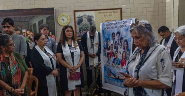 People offer prayers for crew members of the Air India flight that crashed in Ahmedabad last month during a prayer meeting at a church in Mumbai, India, July 12, 2025. (AP Photo)