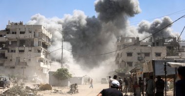 Palestinians watch as the Mhanna tower collapses amid heavy smoke after an Israeli strike in the Tal el-Hawa neighbourhood of Gaza City, northern Gaza Strip, Palestine, Sept. 14, 2025. (AFP Photo)