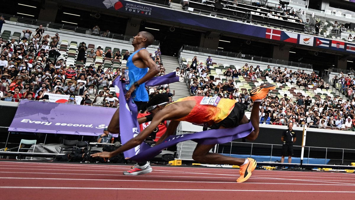 Germany&#039;s athlete Amanal Petros (R) falls as he crosses the finish line behind Tanzania&#039;s athlete Alphonce Felix Simbu in the men&#039;s marathon final during the World Athletics Championships, Tokyo, Japan, Sept. 15, 2025. (AFP Photo)