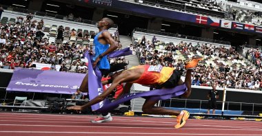 Germany&#039;s athlete Amanal Petros (R) falls as he crosses the finish line behind Tanzania&#039;s athlete Alphonce Felix Simbu in the men&#039;s marathon final during the World Athletics Championships, Tokyo, Japan, Sept. 15, 2025. (AFP Photo)