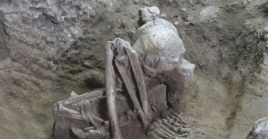 This undated photo provided by Hirofumi Matsumura shows a 9,000-year-old mummy in Guangxi, China, in a squatting position. (Hirofumi Matsumura via AP)