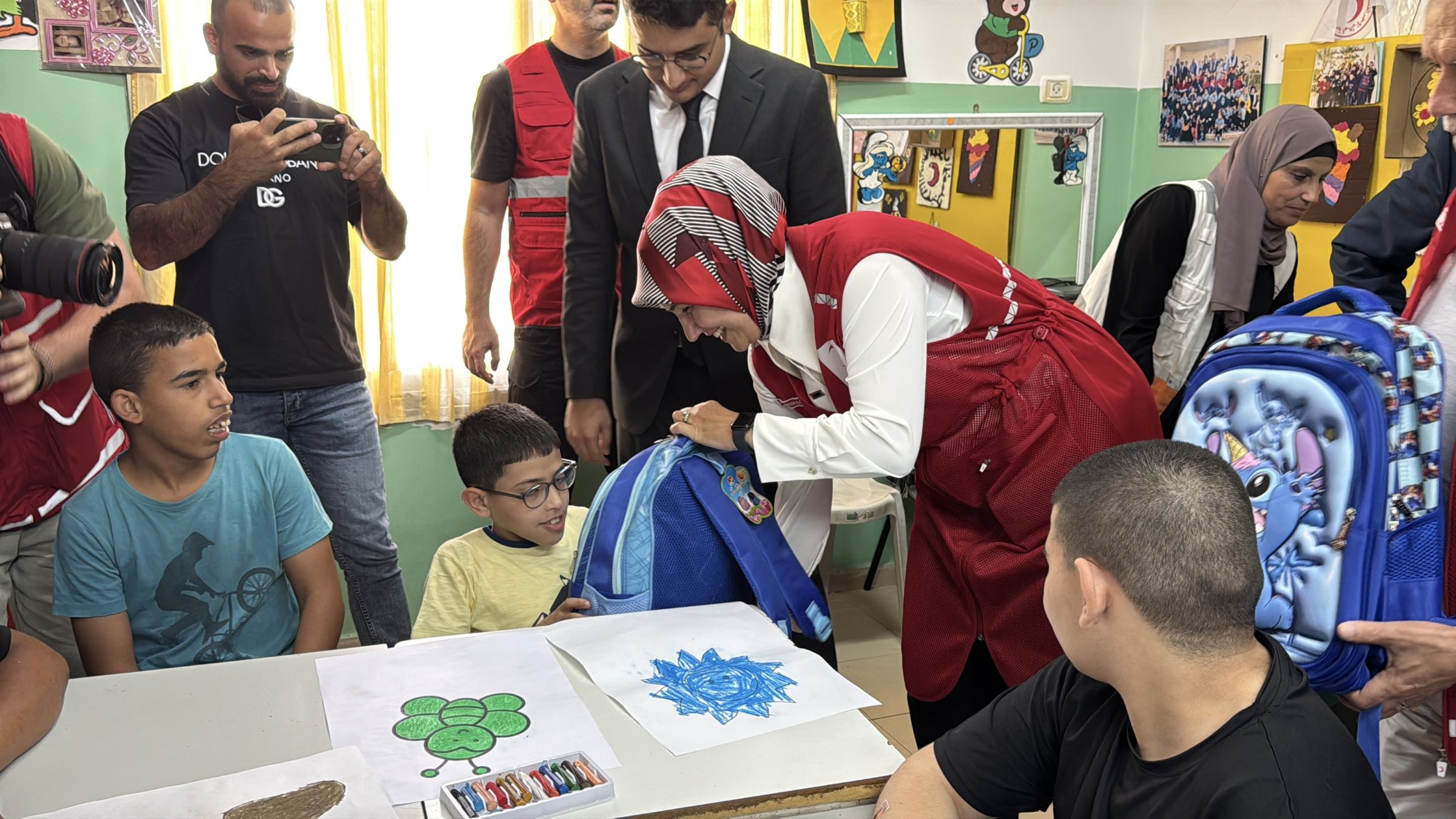 Turkish Red Crescent (Kızılay) President Fatma Meriç Yılmaz and volunteers distribute aid bags to children in Jericho, West Bank, Palestine, Sept. 15, 2025. (AA Photo)