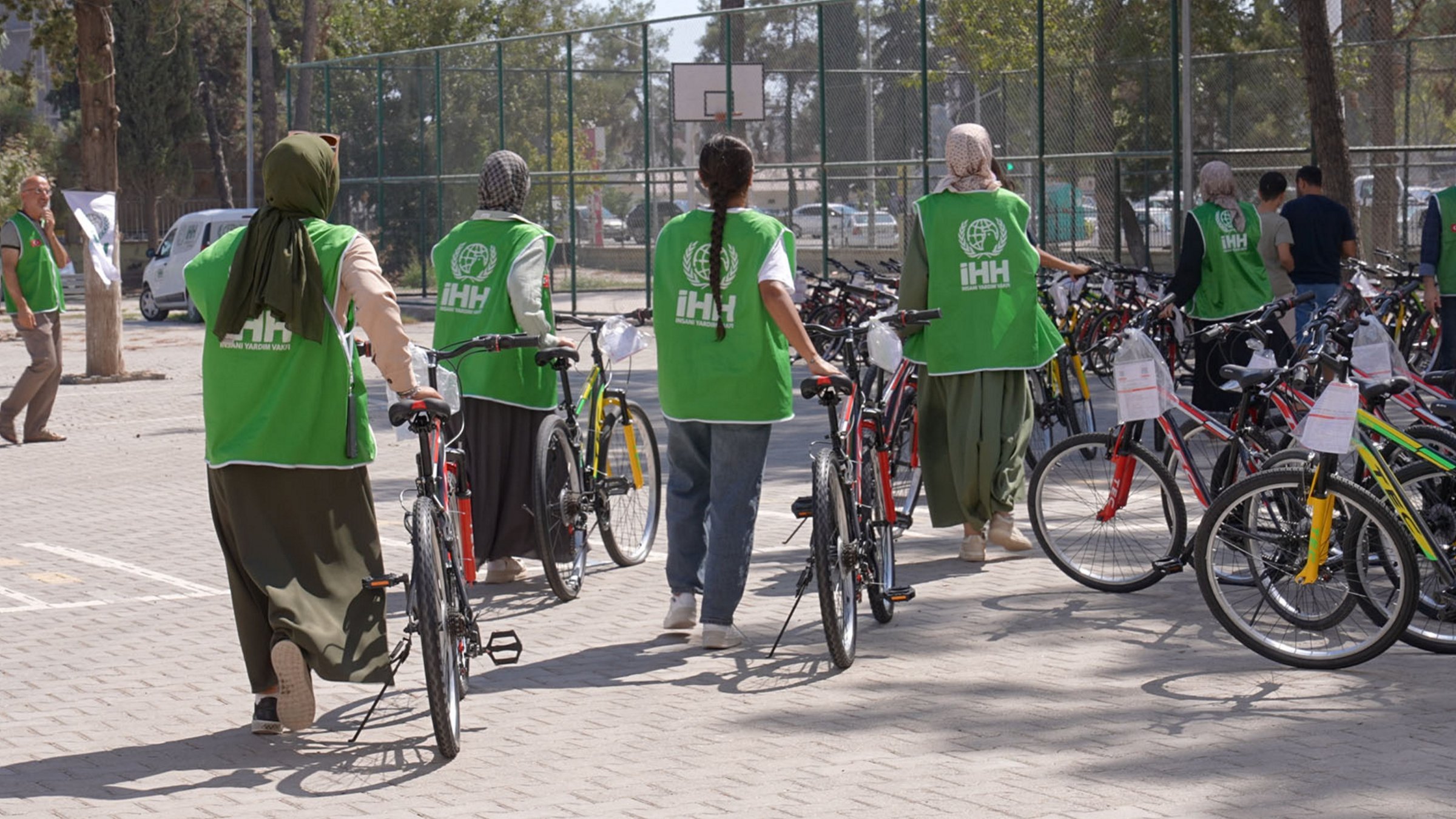 Humanitarian Relief Foundation (IHH) volunteers hand out bicycles to children affected by the Feb. 6, 2023 earthquakes, Adıyaman, Türkiye, Sept. 15, 2025. (AA Photo)