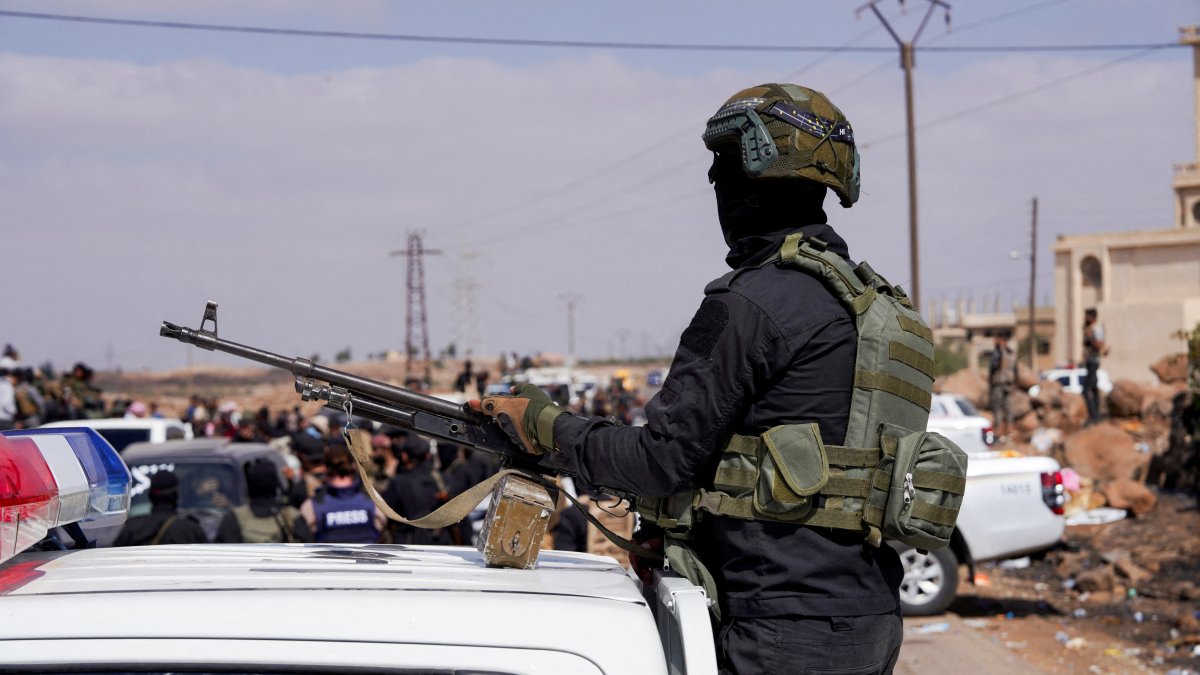 A member of the Internal Security Forces holds a gun at an Internal Security Forces&#039; checkpoint working to prevent Bedouin fighters from advancing towards Suwayda, July 20, 2025. (Reuters File Photo)