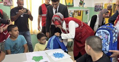 Turkish Red Crescent (Kızılay) President Fatma Meriç Yılmaz and volunteers distribute aid bags to children in Jericho, West Bank, Palestine, Sept. 15, 2025. (AA Photo)
