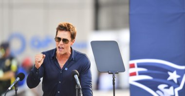 Former New England Patriots quarterback Tom Brady speaks after a bronze statue of himself was unveiled in Patriot Place Plaza before an NFL preseason football game between the Washington Commanders and the New England Patriots, Foxborough, U.S., Aug. 8, 2025. (AP Photo)