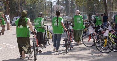 Humanitarian Relief Foundation (IHH) volunteers hand out bicycles to children affected by the Feb. 6, 2023 earthquakes, Adıyaman, Türkiye, Sept. 15, 2025. (AA Photo)