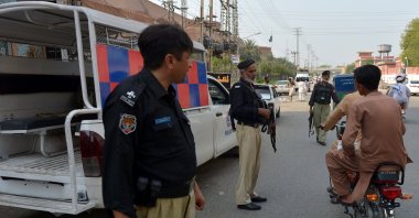 Pakistani security officials stand guard at a checkpoint, as security has been intensified after 12 soldiers were killed near the Pak-Afghan border, in Peshawar, Khyber Pakhtunkhwa province, Pakistan, Sept. 13, 2025. (EPA Photo)