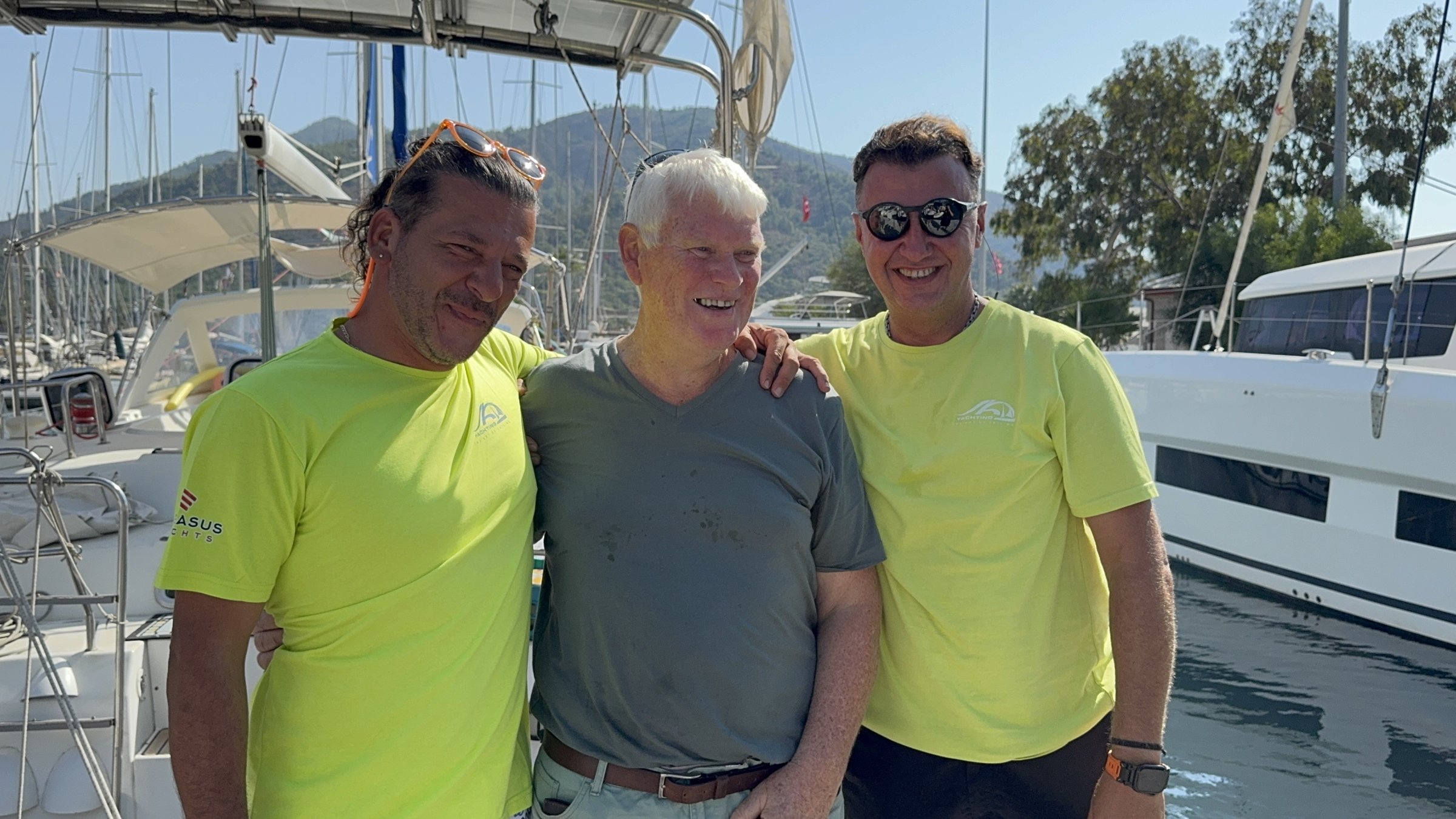 British sailor Nick Chapman (C) poses with two Turkish captains who saved his life, Marmaris, southwestern Türkiye, Sept. 17, 2025. (IHA Photo)