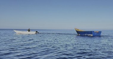 A boat used by migrants to cross the Mediterranean Sea is towed from Tripiti beach to the Karave the port of Gavdos, Greece, Monday, July 7, 2025. (AP File Photo)