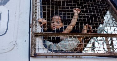 A displaced Palestinian child, fleeing northern Gaza with their family due to an Israeli military operation, looks out of a truck, central Gaza Strip, Palestine, Sept. 18, 2025. (Reuters Photo)