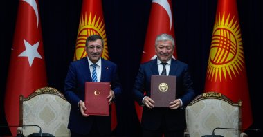 Vice President Cevdet Yılmaz and Kyrgyz Cabinet Chairman Adylbek Kasymaliev (R) hold the new bilateral action plan they signed in Bishkek, Kyrgyzstan, Sept. 18, 2025. (AA Photo)