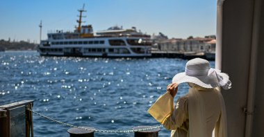 A passenger waits near the Pasabahçe ferryboat docked at Kabataş port, Istanbul, Türkiye, Aug. 21, 2025. (AFP Photo)