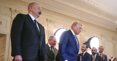 Azerbaijani President Ilham Aliyev (L), Armenian Prime Minister Nikol Pashinyan (L-2), and U.S. President Donald Trump (C) arrive for a trilateral signing ceremony in the State Dining Room of the White House, Washington, U.S., Aug. 8, 2025. (AP Photo)