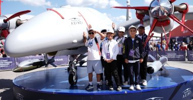 Children pose with a Bayraktar Akıncı drone, one of Türkiye&#039;s leading uncrewed combat aerial vehicles, during the Teknofest aviation and technology festival at Atatürk Airport, Istanbul, Türkiye, Sept. 19, 2025. (AA Photo)