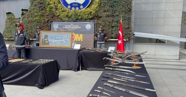 Historical artifacts, including coins, mosaics and a stolen calligraphy panel, are displayed after police operations, Istanbul, Türkiye, Sept. 19, 2025. (IHA Photo)