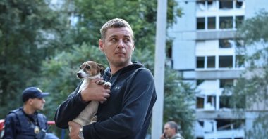 A resident holds his dog as he stands near a residential building damaged during a Russian missile strike, amid Russia&#039;s attack on Ukraine, in Dnipro, Ukraine Sept. 20, 2025. (Reuters Photo)