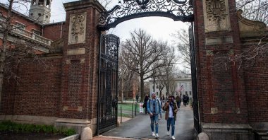 People walk through a gate as they exit Harvard Yard on the campus of Harvard University campus in Cambridge, Massachussetts, U.S. on April 15, 2025. (AFP Photo)