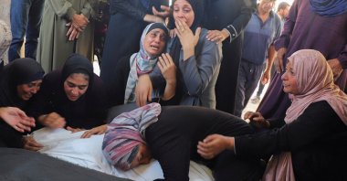 Mourners react as a relative embraces body bags during the funeral for members of the Abu Amsha family, killed in an Israeli strike in Gaza City, Gaza, Palestine, Sept. 21, 2025. (Reuters Photo)