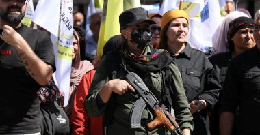 A YPG terrorist carries a weapon during a pro-YPG rally, Qamishli, Syria, Sept. 17, 2025. (Reuters Photo)