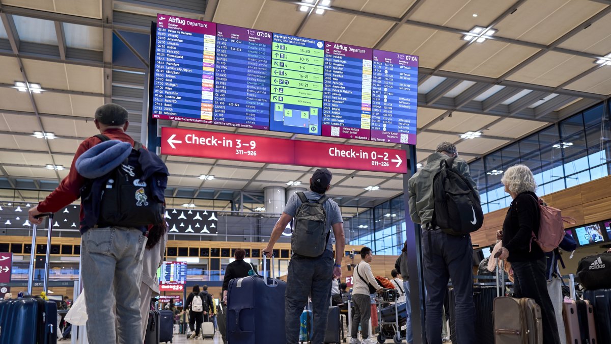 Passengers are seen in front of the check-in counters in Terminal 1 at Berlin Brandenburg Airport after a widespread cyberattack on European airports, Sch&#039;nefeld, Germany, Sept. 22, 2025. (AP Photo)