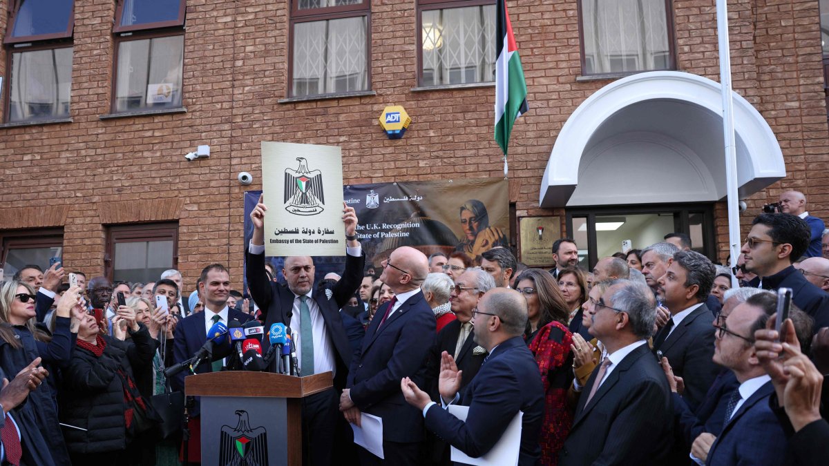 Head of the Palestine Mission to the U.K., Husam Zomlot holds a plaque with the words "Embassy of the State of Palestine," during a flag-raising ceremony outside their Mission in west London, U.K., Sept. 22, 2025. (AFP Photo)