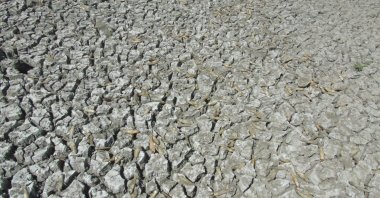 The cracked desert floor is visible on the drying land as water levels drop to 30% at Tahtaköprü Dam, Gaziantep, Türkiye, Sept. 22, 2025. (AA Photo)