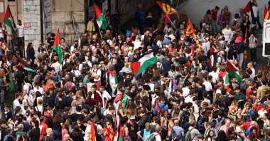 People gather for a demonstration, as dockworkers take part in a strike near the port of Genoa as part of a nationwide "Let&#039;s Block Everything" protest, with activists calling for a halt to arms shipments to Israel, Genoa, Italy, Sept. 22, 2025. (Reuters Photo)