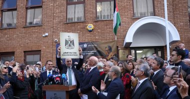 Head of the Palestine Mission to the U.K., Husam Zomlot holds a plaque with the words "Embassy of the State of Palestine," during a flag-raising ceremony outside their Mission in west London, U.K., Sept. 22, 2025. (AFP Photo)
