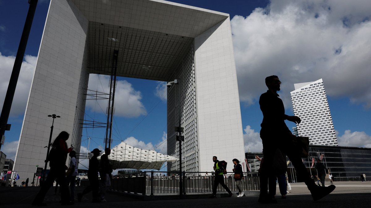 People walk past the Grande Arche at the financial and business district of La Defense, Paris, France, Sept. 12, 2025. (Reuters Photo)